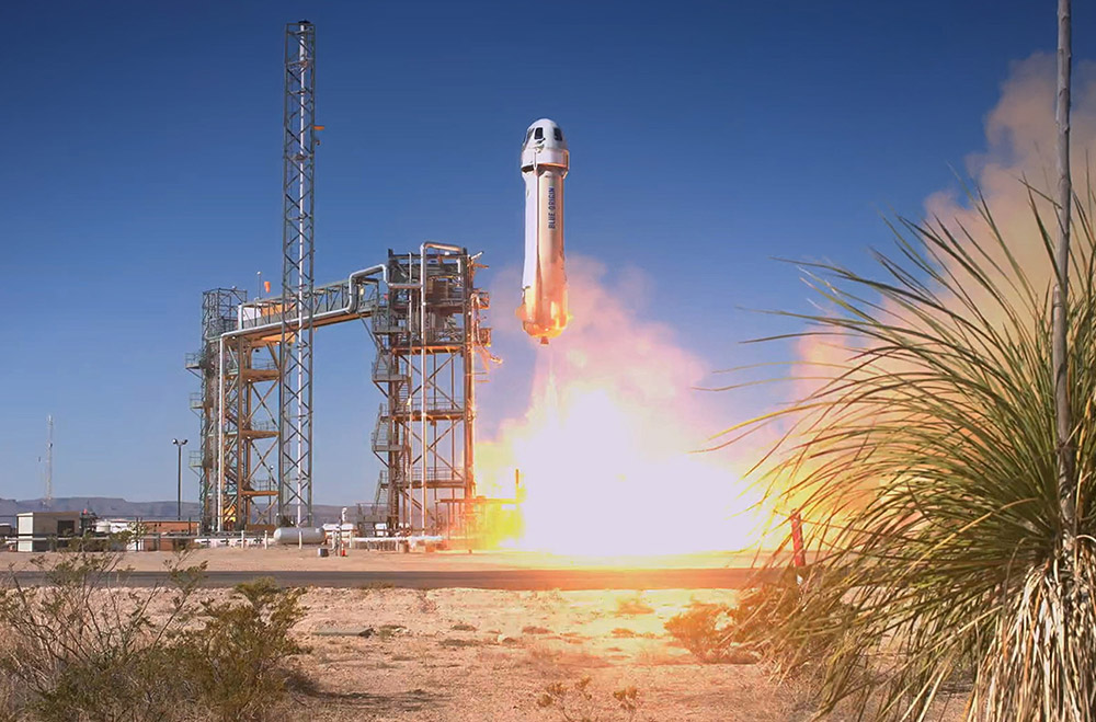 Blue Origin’s New Shepherd Rocket lifts off from a launch pad in West Texas. Courtesy: Blue Origin.