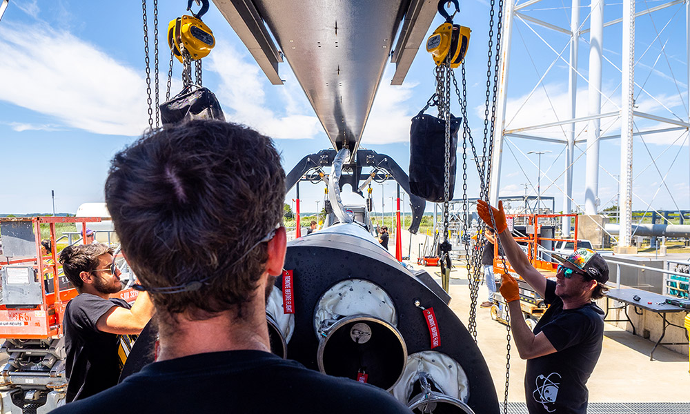 Rocket Lab employees guide aerospace hardware into position at the company’s launch complex in Accomack County on Virginia’s Eastern Shore, where the growing space sector is creating demand for specialized engineering and advanced manufacturing talent.